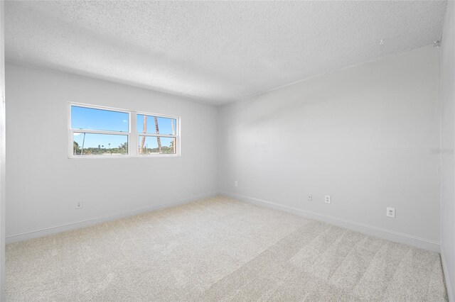 10216 Regal Dr Unit 208, Largo, FL 33774 - carpeted spare room with a textured ceiling and baseboards