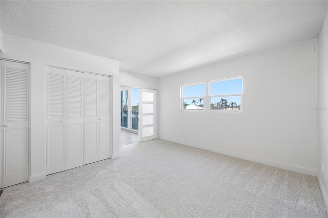 10216 Regal Dr Unit 208, Largo, FL 33774 - unfurnished bedroom featuring carpet floors, baseboards, and a textured ceiling