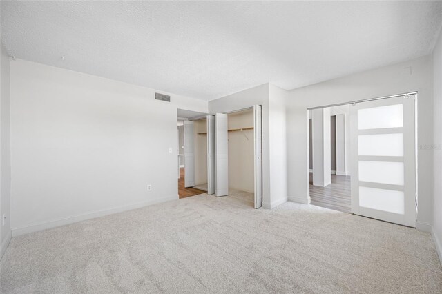 10216 Regal Dr Unit 208, Largo, FL 33774 - unfurnished bedroom featuring carpet floors, baseboards, and a textured ceiling