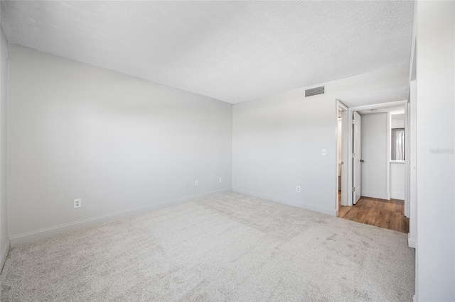 10216 Regal Dr Unit 208, Largo, FL 33774 - spare room with carpet, baseboards, and a textured ceiling