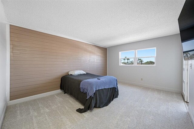 10216 Regal Dr Unit 208, Largo, FL 33774 - carpeted bedroom with wooden walls, a textured ceiling, and baseboards