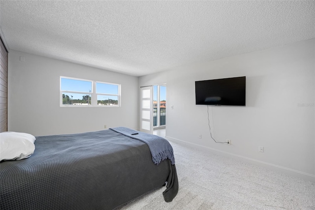 10216 Regal Dr Unit 208, Largo, FL 33774 - bedroom featuring a textured ceiling, carpet flooring, and baseboards
