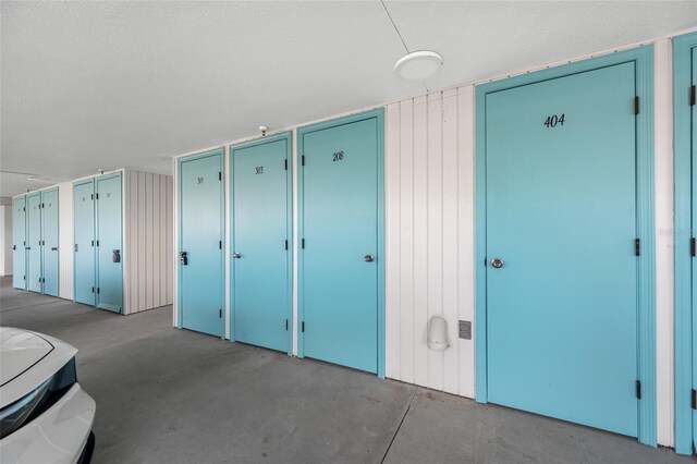 10216 Regal Dr Unit 208, Largo, FL 33774 - unfurnished bedroom featuring multiple closets, concrete floors, and a textured ceiling