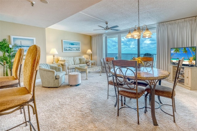 14146 Gulf Blvd Unit 4B, Madeira Beach, FL 33708 - dining space featuring light colored carpet, a textured ceiling, a chandelier, a ceiling fan, and a wall of windows