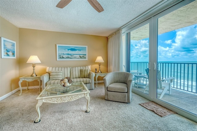 14146 Gulf Blvd Unit 4B, Madeira Beach, FL 33708 - carpeted living room with a ceiling fan, a textured ceiling, baseboards, and a water view