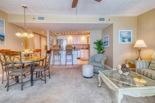 14146 Gulf Blvd Unit 4B, Madeira Beach, FL 33708 - living room featuring light carpet, a textured ceiling, a ceiling fan, and baseboards