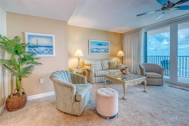 14146 Gulf Blvd Unit 4B, Madeira Beach, FL 33708 - living room with carpet flooring, a textured ceiling, baseboards, and ceiling fan