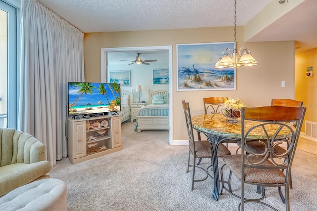 14146 Gulf Blvd Unit 4B, Madeira Beach, FL 33708 - dining room with light colored carpet, a textured ceiling, a chandelier, a ceiling fan, and baseboards