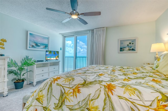 14146 Gulf Blvd Unit 4B, Madeira Beach, FL 33708 - bedroom featuring access to outside, carpet floors, a ceiling fan, and a textured ceiling