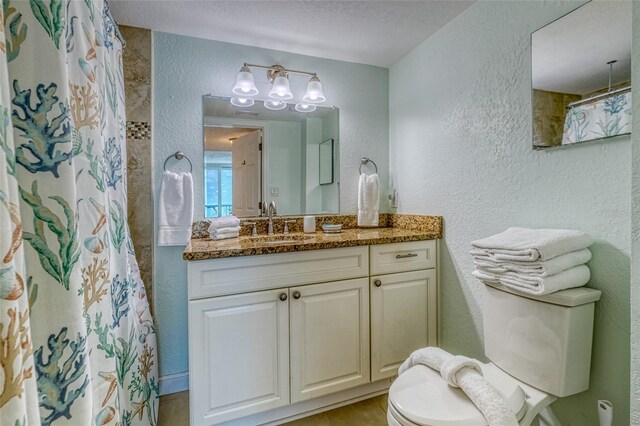 14146 Gulf Blvd Unit 4B, Madeira Beach, FL 33708 - full bathroom with a textured wall, toilet, vanity, a chandelier, and a textured ceiling