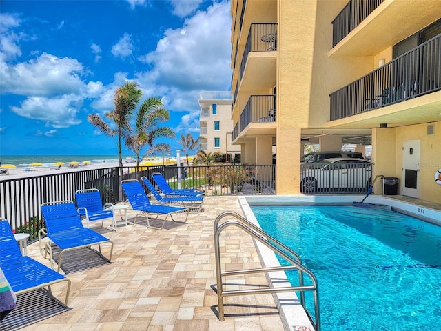 14146 Gulf Blvd Unit 4B, Madeira Beach, FL 33708 - community pool featuring fence, a patio area, and a water view