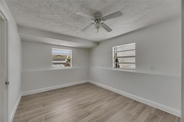 825 Seabreeze Dr, Ruskin, FL 33570 - unfurnished room featuring light wood-style flooring, a textured ceiling, baseboards, and a ceiling fan