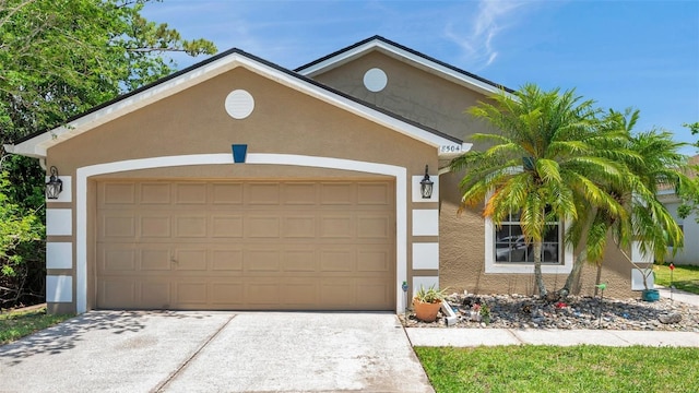 8504 Tidal Bay Ln, Tampa, FL 33635 - view of front of house featuring an attached garage, driveway, and stucco siding