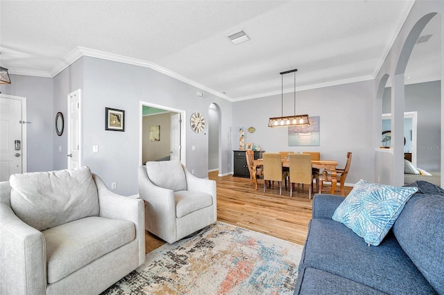 8504 Tidal Bay Ln, Tampa, FL 33635 - living area with arched walkways, light wood-style flooring, crown molding, and baseboards