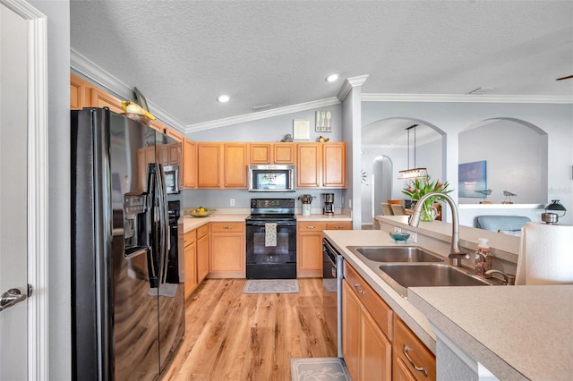 8504 Tidal Bay Ln, Tampa, FL 33635 - kitchen with black appliances, crown molding, a sink, light wood-style flooring, and light countertops