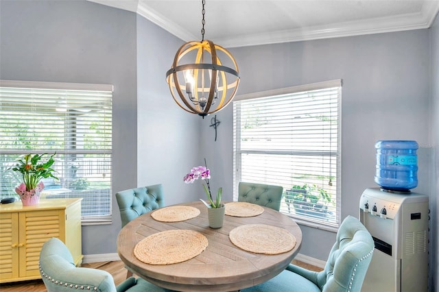 8504 Tidal Bay Ln, Tampa, FL 33635 - dining space featuring a chandelier, baseboards, light wood-style flooring, and crown molding