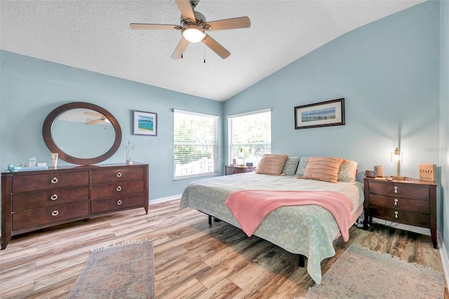8504 Tidal Bay Ln, Tampa, FL 33635 - bedroom featuring lofted ceiling, wood finished floors, a textured ceiling, baseboards, and a ceiling fan