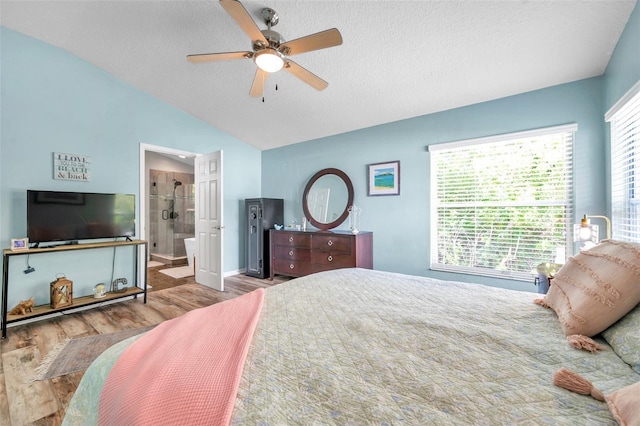 8504 Tidal Bay Ln, Tampa, FL 33635 - bedroom with wood finished floors, lofted ceiling, a textured ceiling, baseboards, and ceiling fan