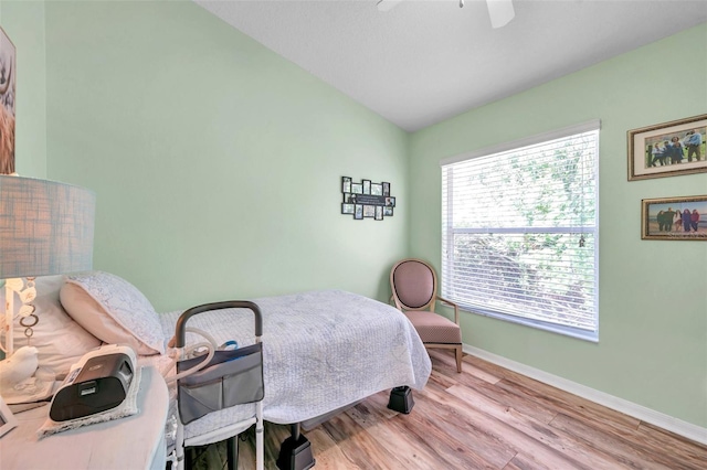 8504 Tidal Bay Ln, Tampa, FL 33635 - bedroom with lofted ceiling, baseboards, wood finished floors, and ceiling fan