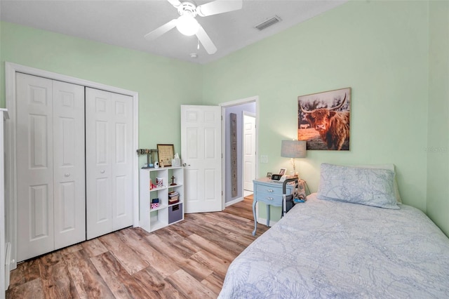 8504 Tidal Bay Ln, Tampa, FL 33635 - bedroom with wood finished floors, a closet, and ceiling fan