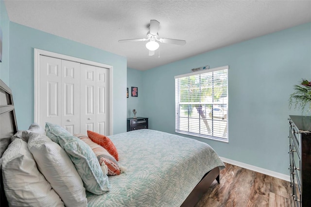8504 Tidal Bay Ln, Tampa, FL 33635 - bedroom with a closet, dark wood-type flooring, baseboards, and a ceiling fan