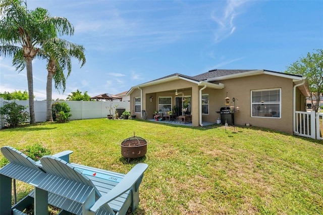 8504 Tidal Bay Ln, Tampa, FL 33635 - rear view of house featuring ceiling fan, a fire pit, stucco siding, and a patio