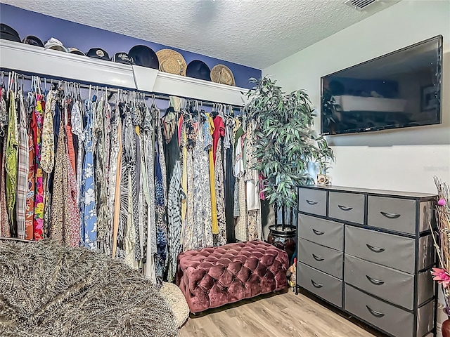 spacious closet featuring wood finished floors