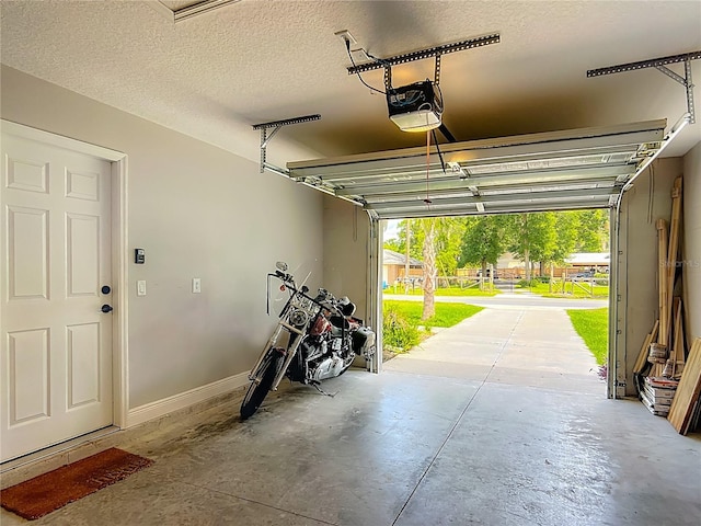 garage with a garage door opener and baseboards