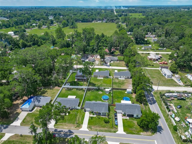 aerial view of property and surrounding area with nearby suburban area