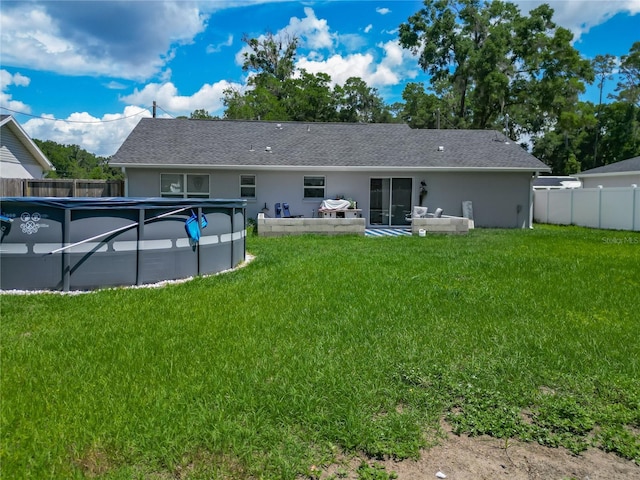 rear view of house featuring stucco siding