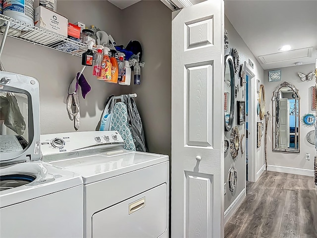 washroom with separate washer and dryer, wood finished floors, and baseboards