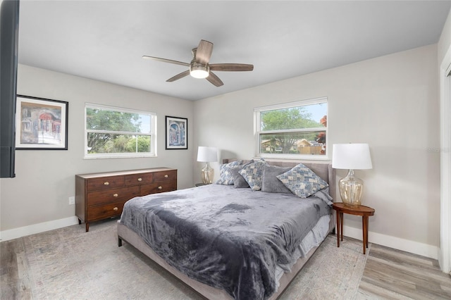 1530 Picardy Cir, Clearwater, FL 33755 - bedroom featuring multiple windows, light wood-type flooring, and a ceiling fan