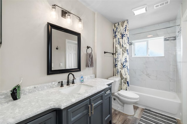 1530 Picardy Cir, Clearwater, FL 33755 - bathroom with vanity, shower / tub combo with curtain, and wood finished floors