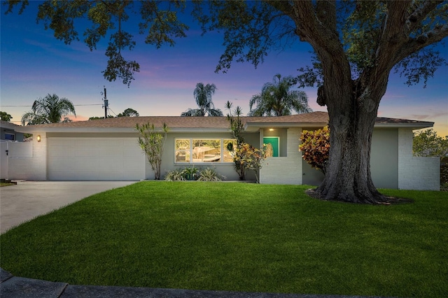 1530 Picardy Cir, Clearwater, FL 33755 - ranch-style home with a garage, concrete driveway, a yard, and brick siding