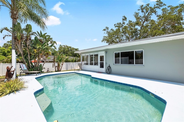 1530 Picardy Cir, Clearwater, FL 33755 - view of swimming pool with a fenced backyard, a sunroom, and a patio