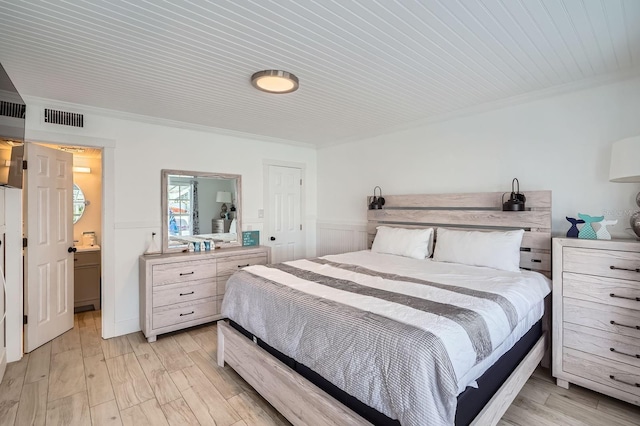 28 Seaside Ct, Holmes Beach, FL 34217 - bedroom with light wood-style floors and crown molding