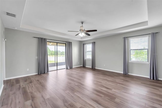 11878 Thicket Wood Dr, Riverview, FL 33579 - spare room with a raised ceiling, ceiling fan, wood finished floors, and baseboards