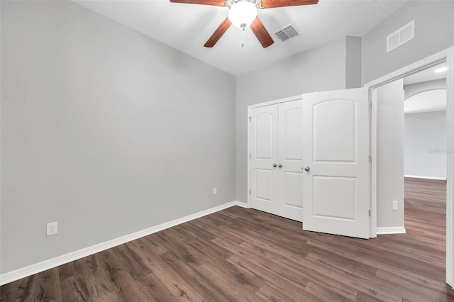 11878 Thicket Wood Dr, Riverview, FL 33579 - unfurnished bedroom with arched walkways, dark wood-style floors, and baseboards