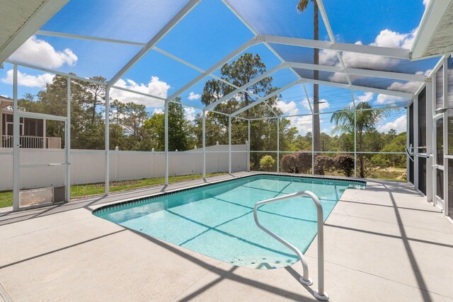 6129 Schalekamp Dr, Spring Hill, FL 34609 - view of swimming pool with a patio area, fence, view of scattered trees, and a lanai