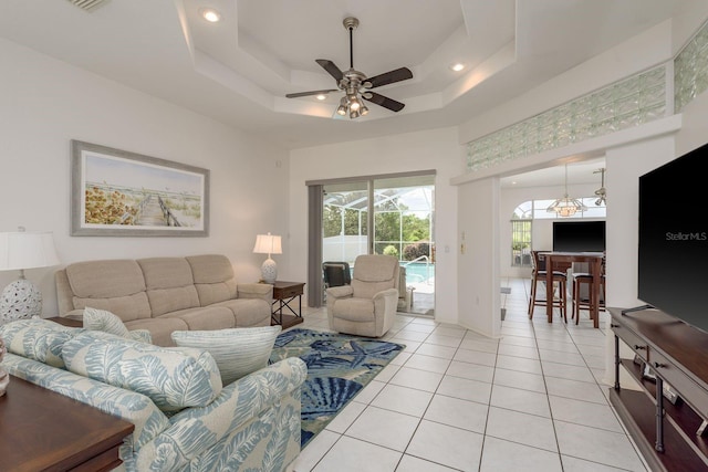 6129 Schalekamp Dr, Spring Hill, FL 34609 - living room featuring ceiling fan, light tile patterned floors, a towering ceiling, and a raised ceiling