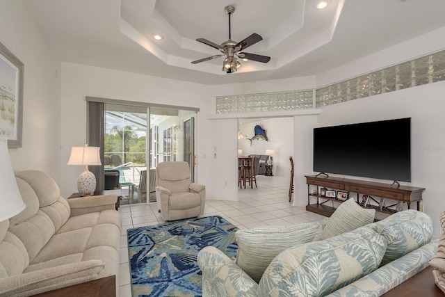 6129 Schalekamp Dr, Spring Hill, FL 34609 - living area featuring a ceiling fan, light tile patterned flooring, a towering ceiling, and a tray ceiling