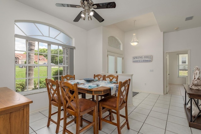 6129 Schalekamp Dr, Spring Hill, FL 34609 - dining area with light tile patterned floors, ceiling fan, and baseboards