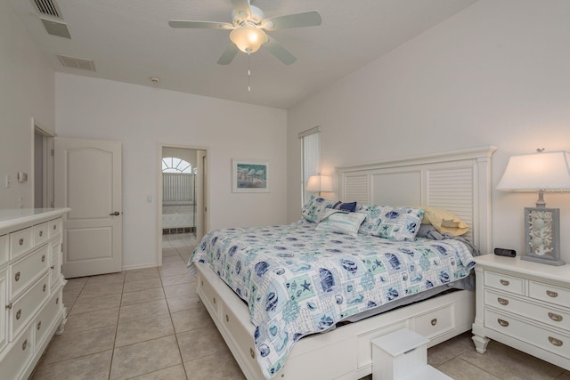 6129 Schalekamp Dr, Spring Hill, FL 34609 - bedroom with light tile patterned floors, connected bathroom, and ceiling fan