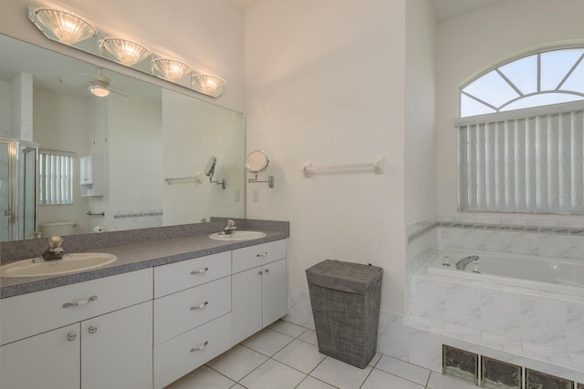 6129 Schalekamp Dr, Spring Hill, FL 34609 - full bath with toilet, double vanity, a ceiling fan, a garden tub, and tile patterned flooring