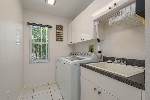 6129 Schalekamp Dr, Spring Hill, FL 34609 - washroom with washing machine and dryer, cabinet space, light tile patterned flooring, and baseboards