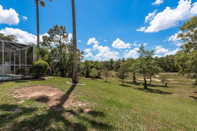 6129 Schalekamp Dr, Spring Hill, FL 34609 - view of grassy yard featuring glass enclosure and an outdoor pool
