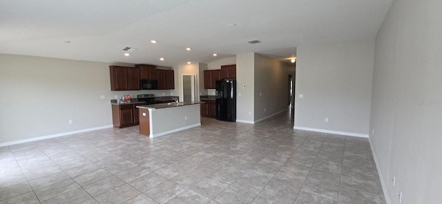 kitchen with black appliances, open floor plan, lofted ceiling, a center island with sink, and recessed lighting