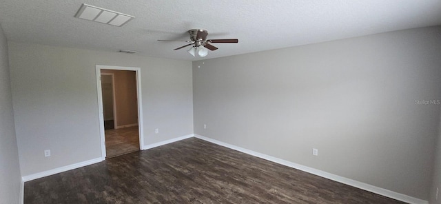empty room featuring ceiling fan, dark wood finished floors, baseboards, and a textured ceiling