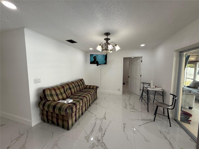 living area with baseboards, a chandelier, light marble finish flooring, recessed lighting, and a textured ceiling