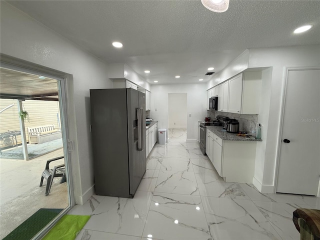 kitchen with stainless steel appliances, baseboards, light marble finish flooring, white cabinets, and recessed lighting